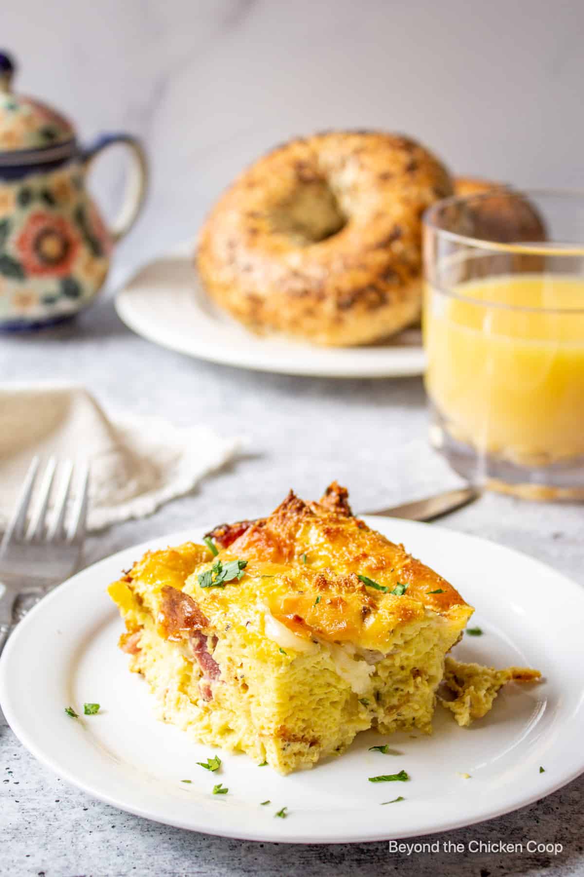 A slice of breakfast strata on a white plate. 