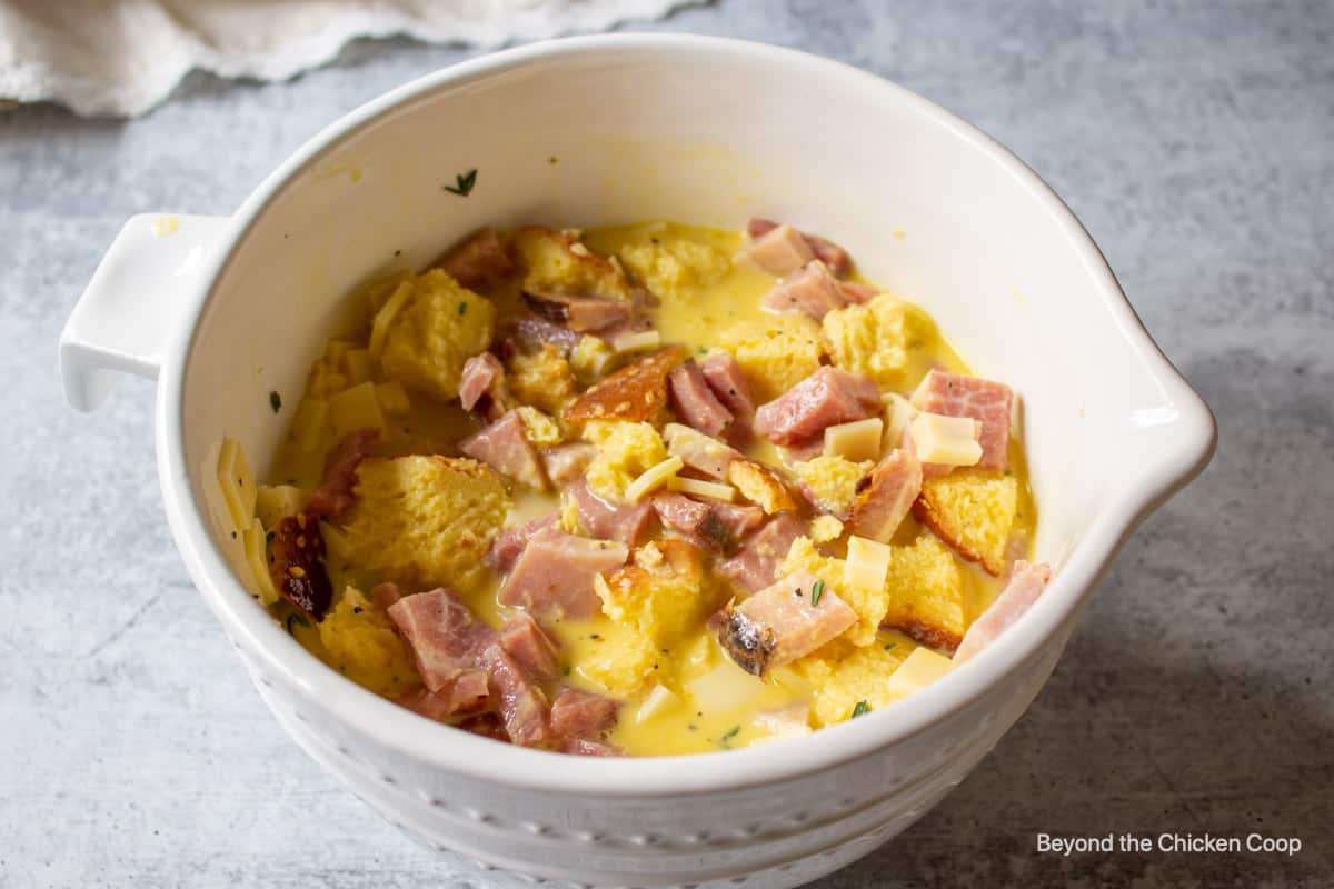 A bowl with eggs, ham and cheese.
