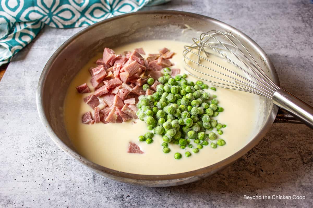 Diced ham and frozen peas in a white sauce.