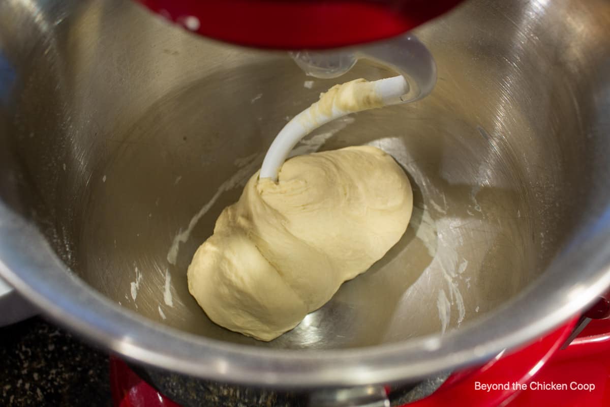 A ball of bread dough in a mixer.
