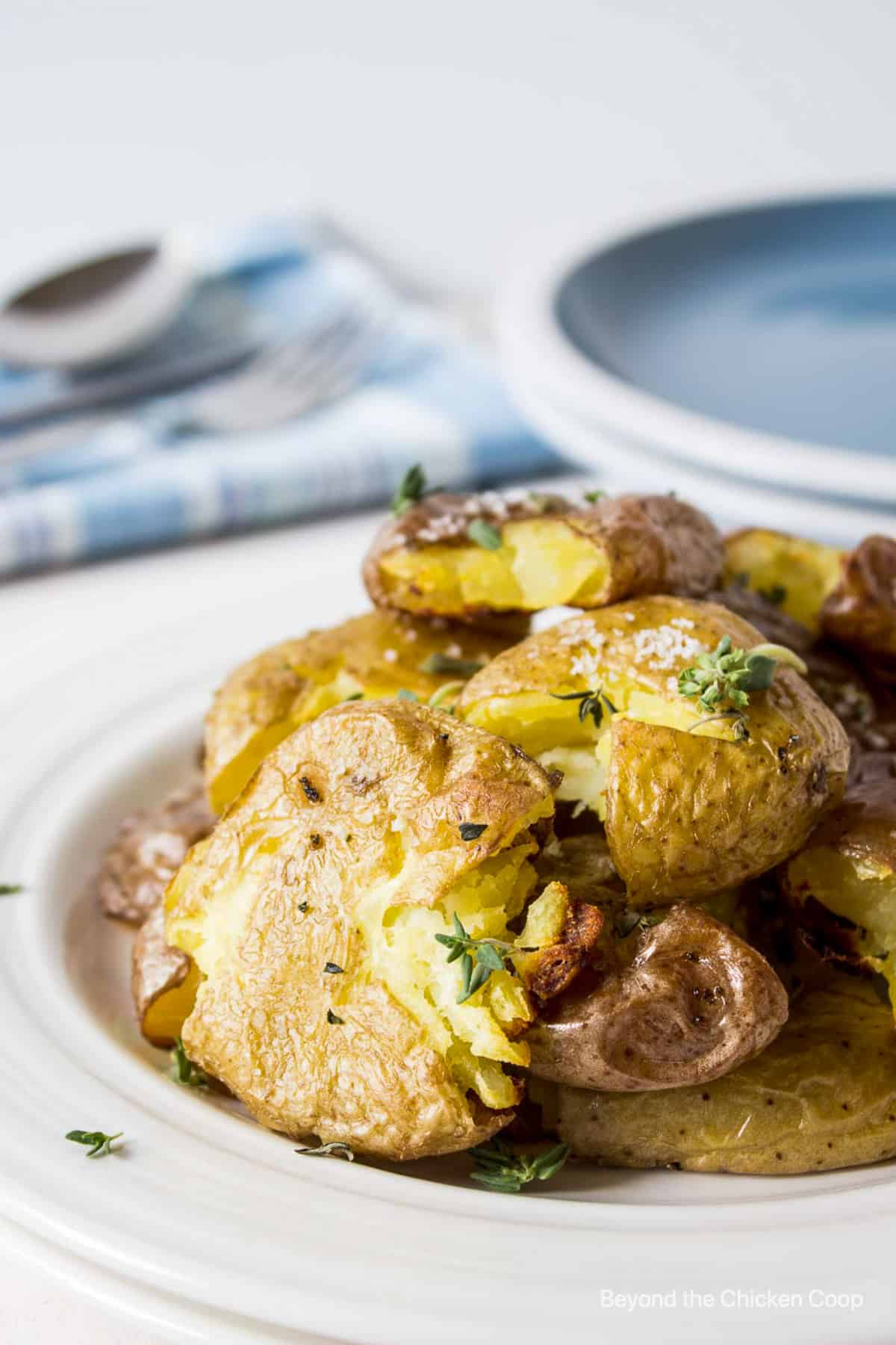 Crispy smashed potatoes on a serving plate.