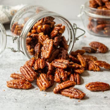 Pecans spilling out of a jar.