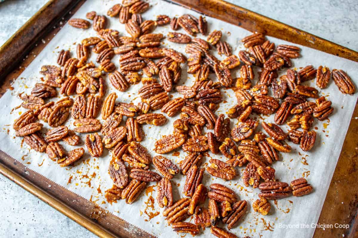 Roasted pecans on a baking sheet.