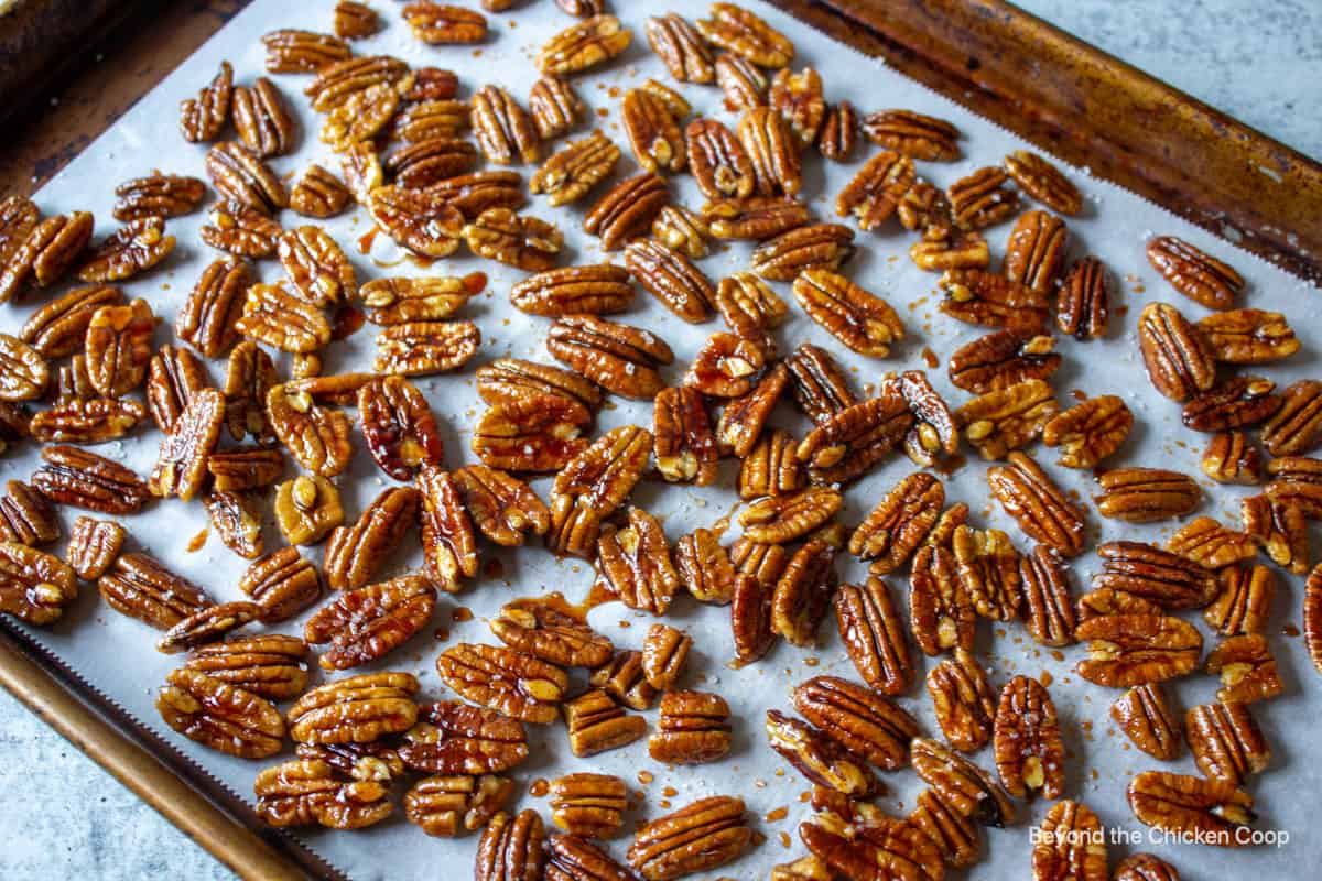 Pecans spread on a baking sheet.