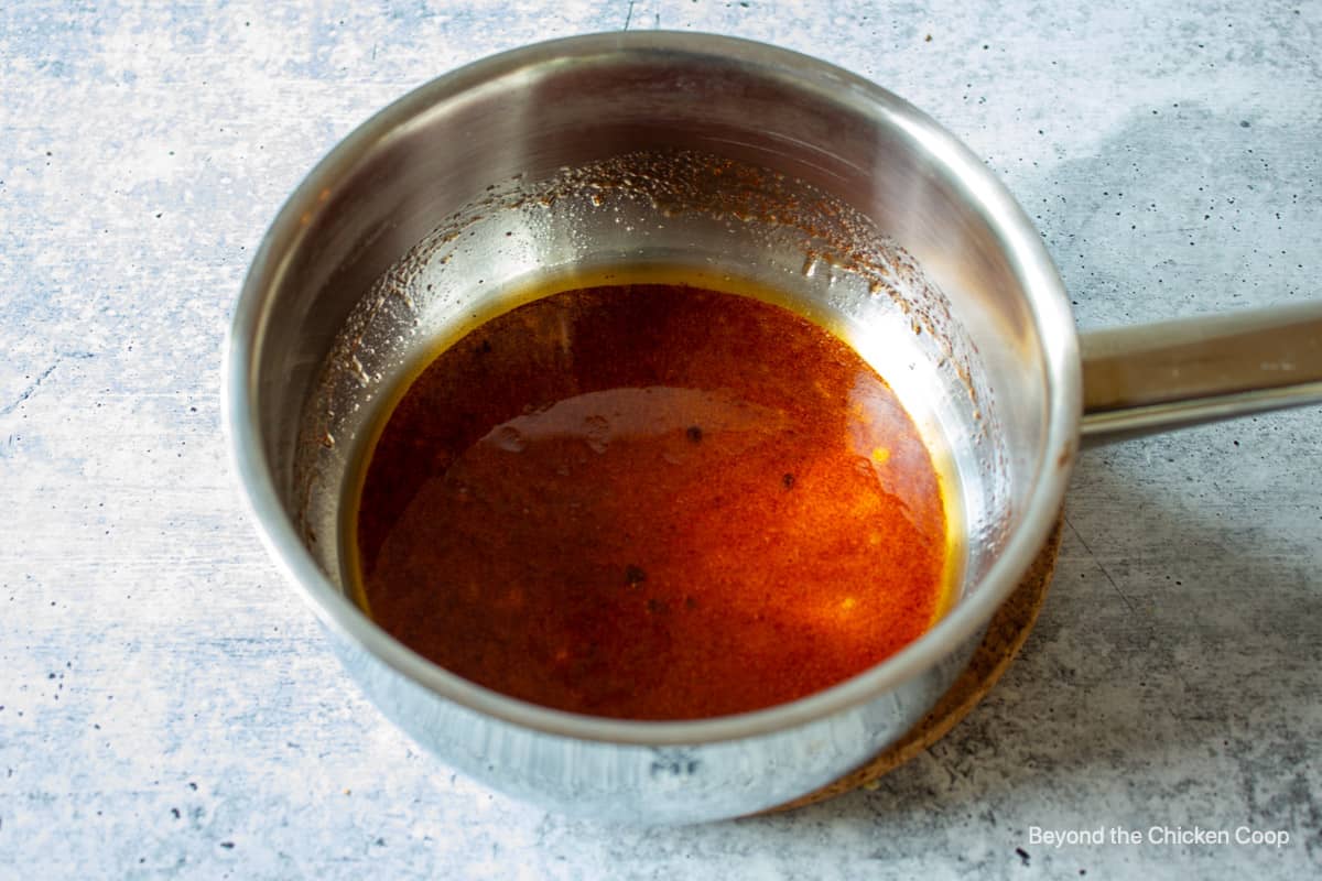 A liquid syrup in a saucepan.