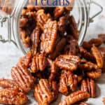 A pile of pecans spilling out of a jar.