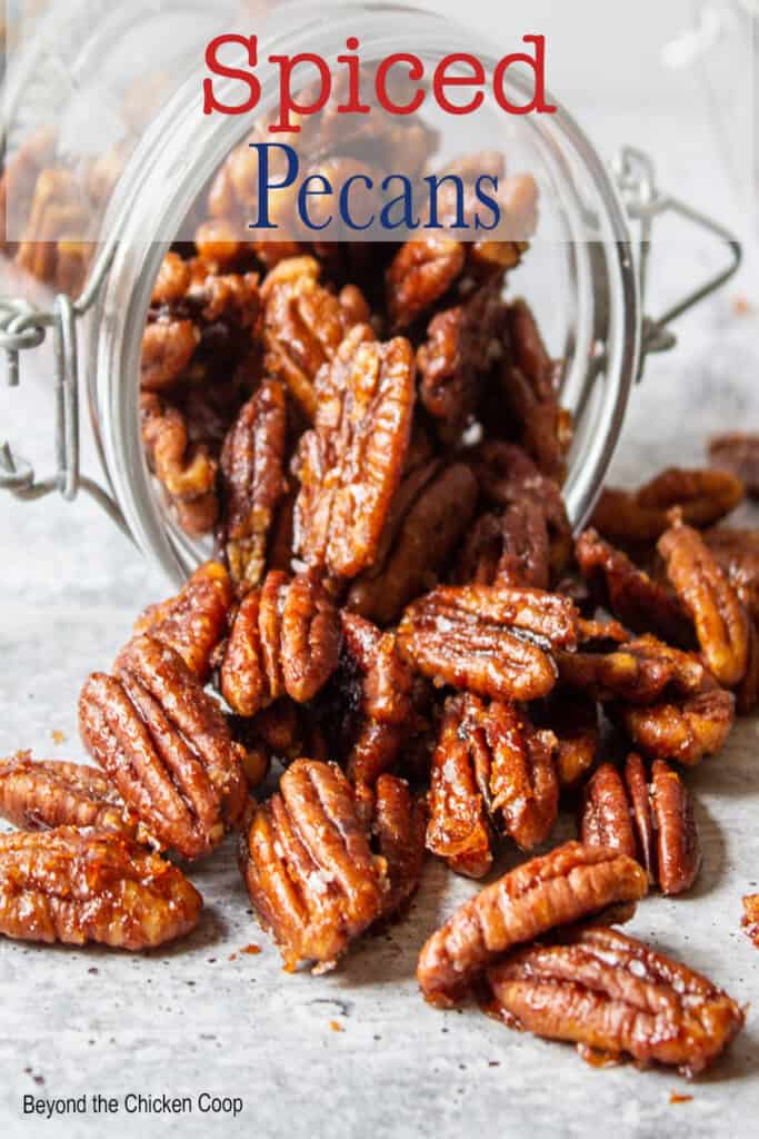 A pile of pecans spilling out of a jar.