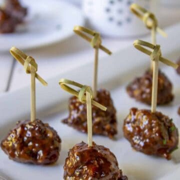 Glazed meatballs with fancy toothpicks.