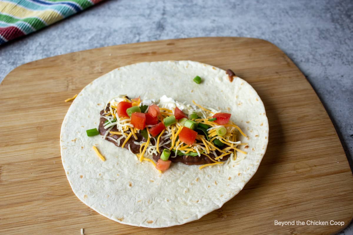 Making a flauta with a flour tortilla.