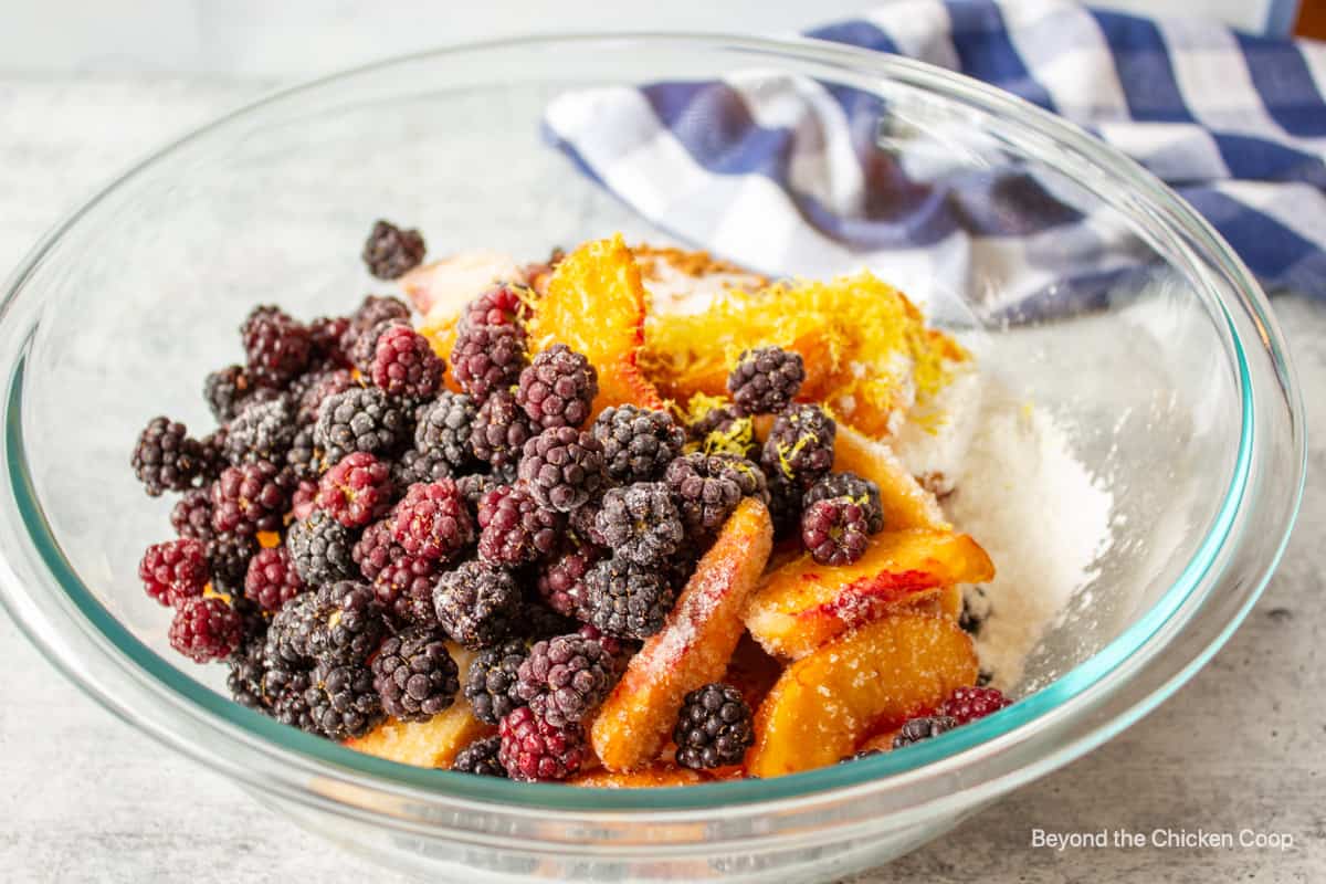 Peaches and blackberries in a bowl.