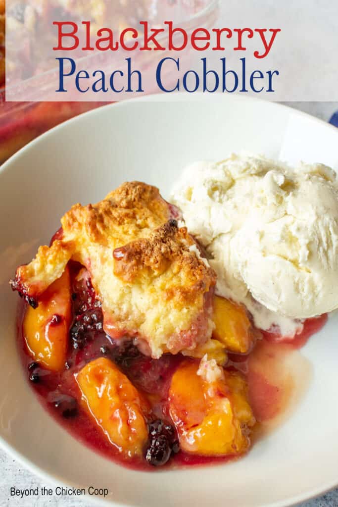 A cobbler with peach slices and blackberries.