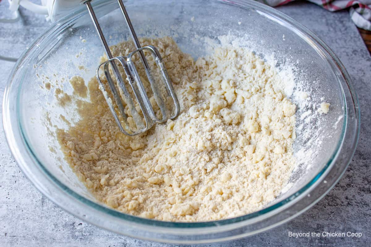 Flour and butter mixed together in a glass bowl.