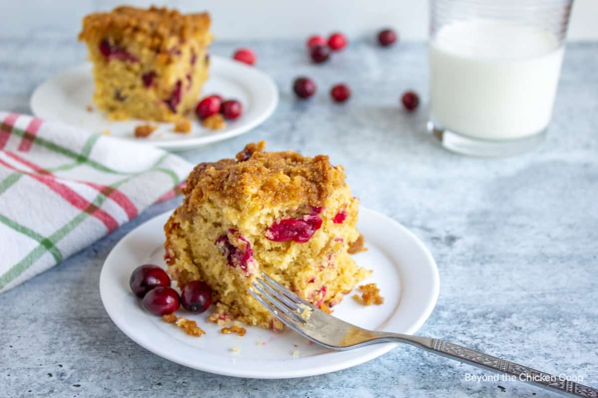 Cranberry coffee cake on a plate with a fork.