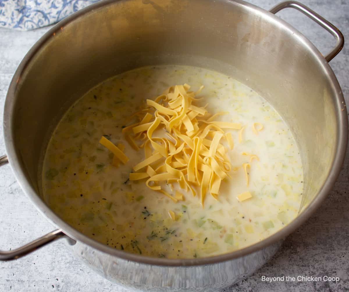 Egg noodles added to soup.