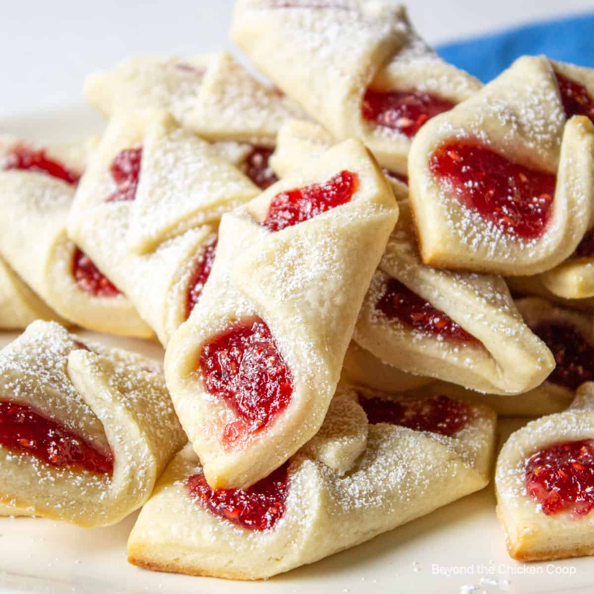 A pile of cookies filled with raspberry jam.