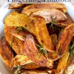 Golden potatoes in a bowl with fresh rosemary.