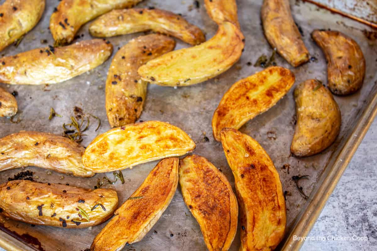 Golden fingerling potatoes on a baking sheet. 