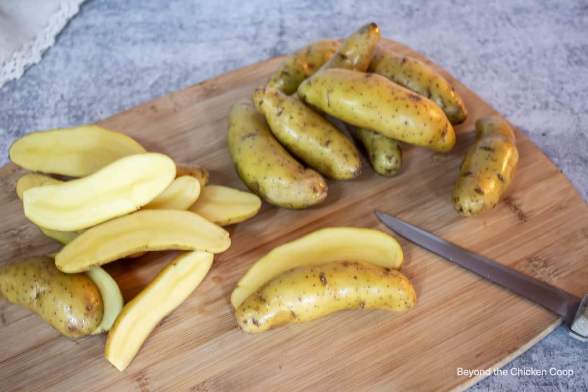 Sliced potatoes on a cutting board.