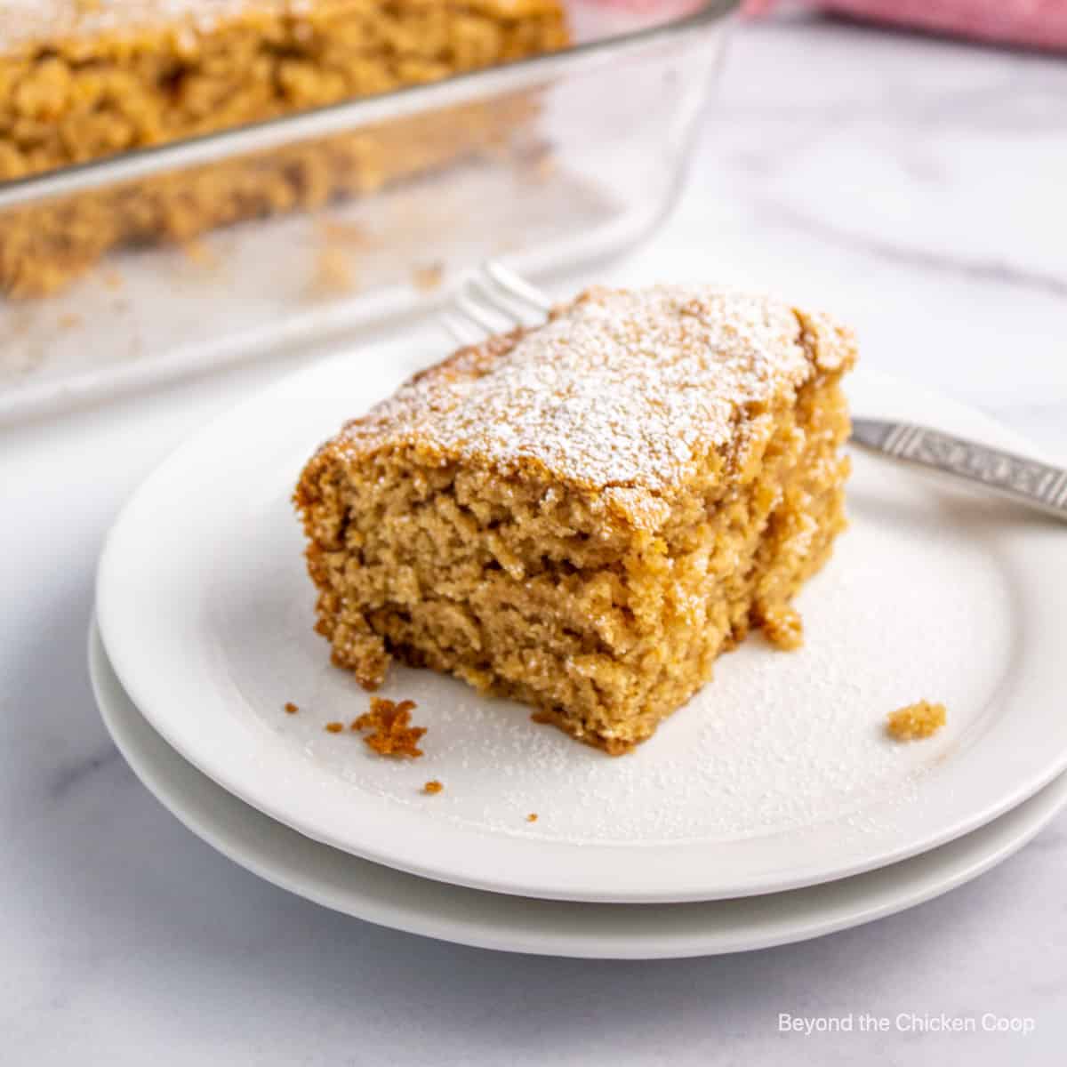 A slice of cake topped with powdered sugar.