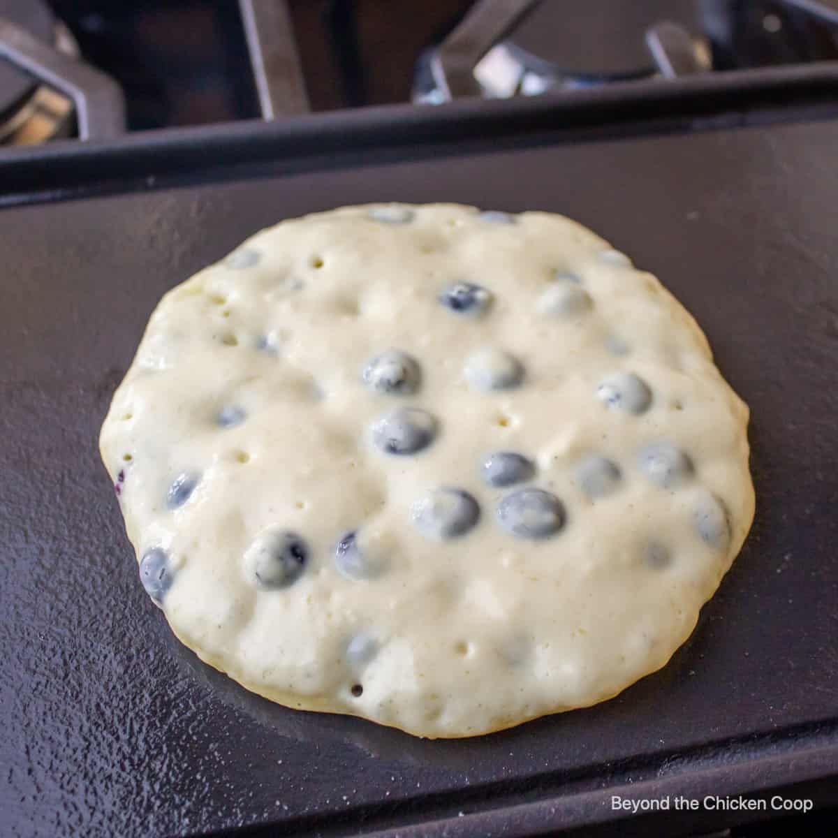 Cooking blueberry pancakes.