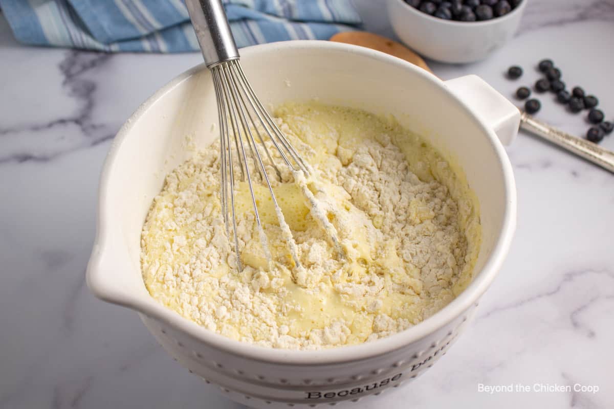 Whisking flour into milk.