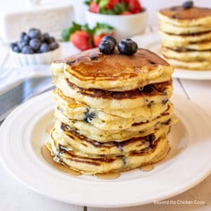 A stack of pancakes with berries.