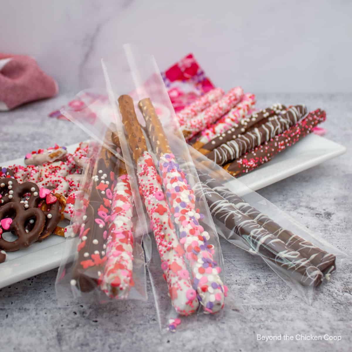 Chocolate dipped pretzels in a clear bag.