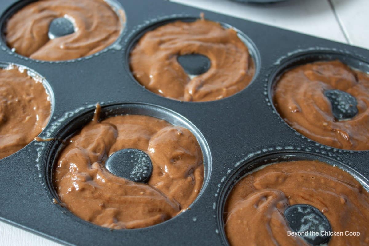 Donut batter in a donut pan.