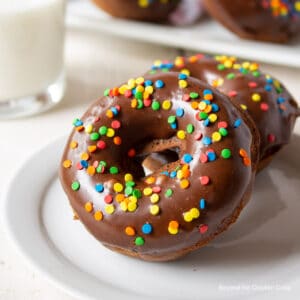 Chocolate donuts with glaze and colorful sprinkles.