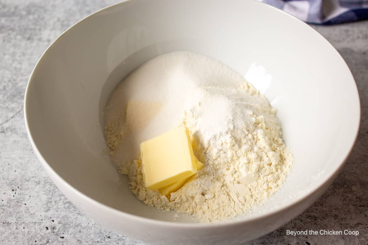 Flour, sugar and butter in a bowl.