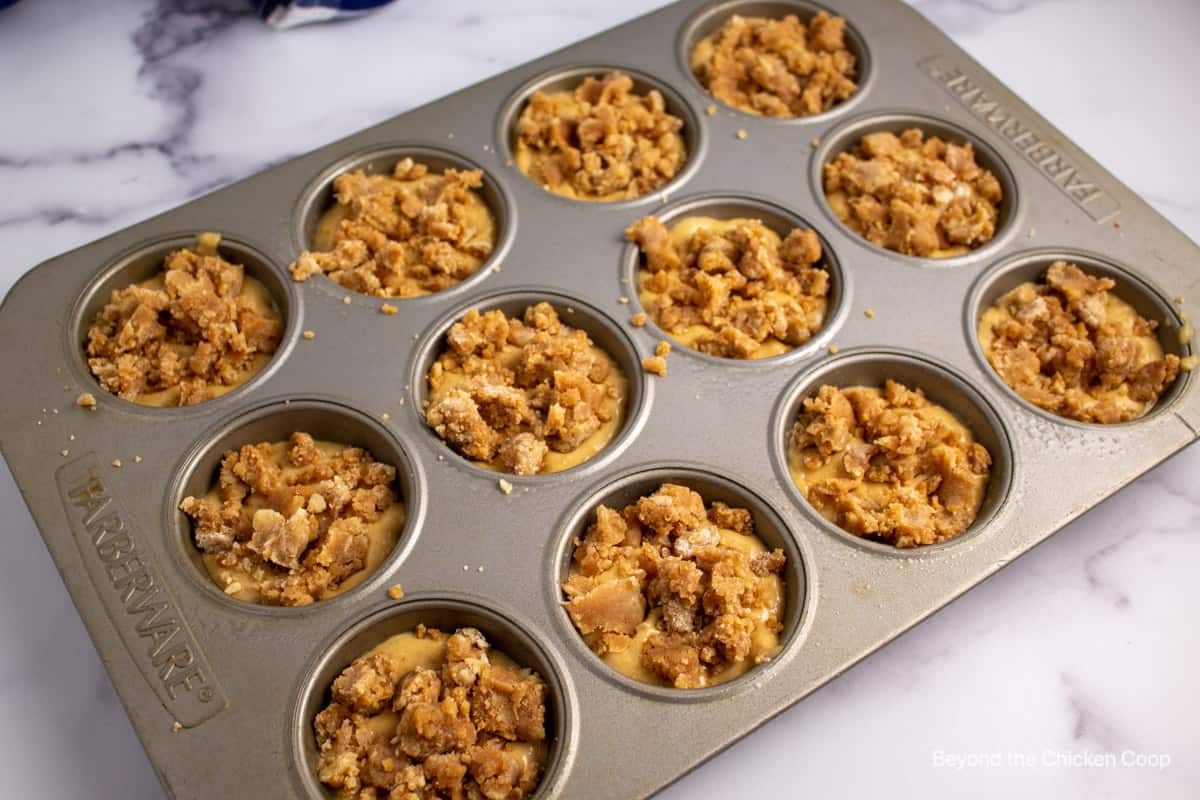 Muffin batter in a muffin tin.