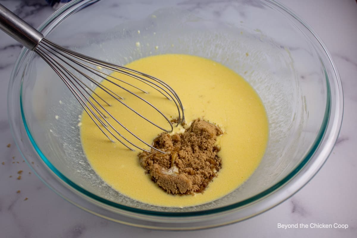 Mixing brown sugar into a milk mixture.