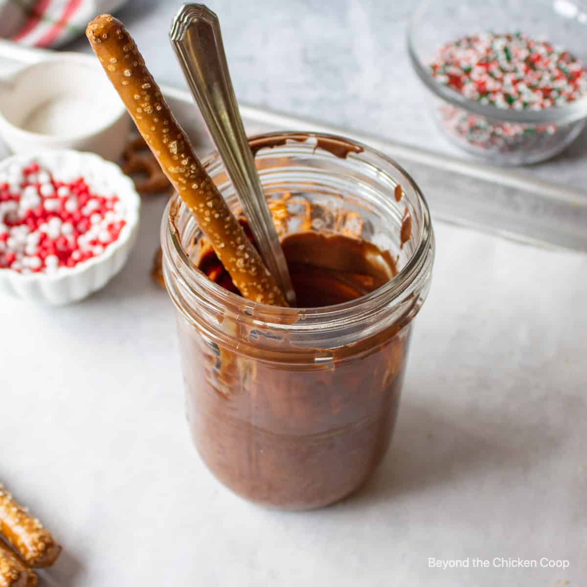 Melted chocolate with a pretzel rod.