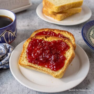 Two slices of toasted bread topped with jam.