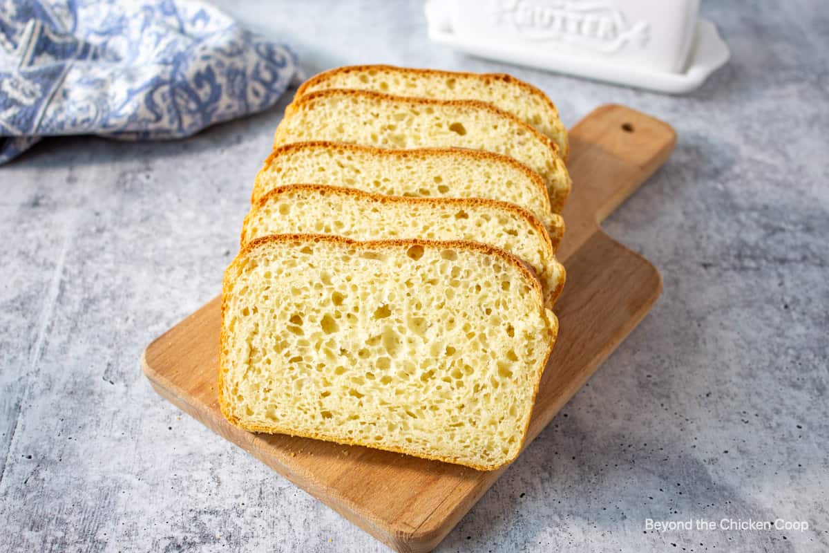 Slices of homemade bread on a wooden board.