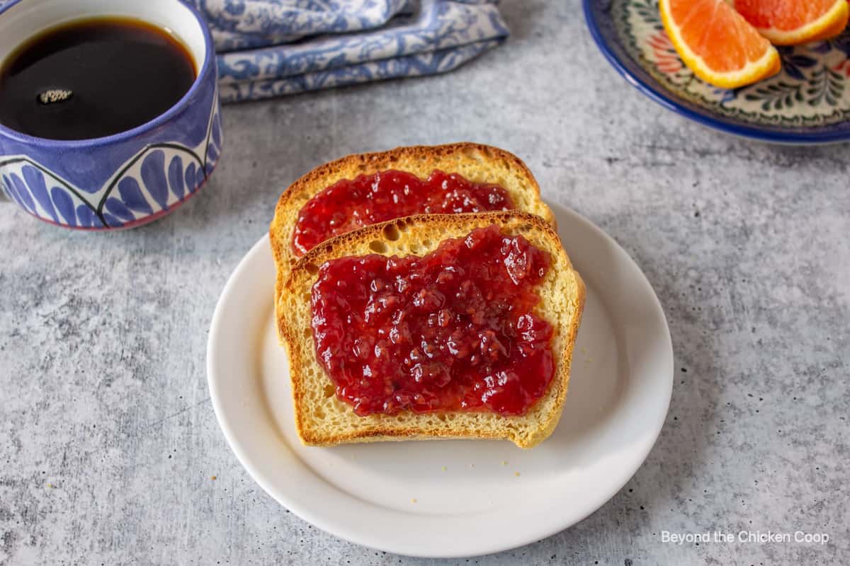 Two slices of toasted bread topped with raspberry jam.