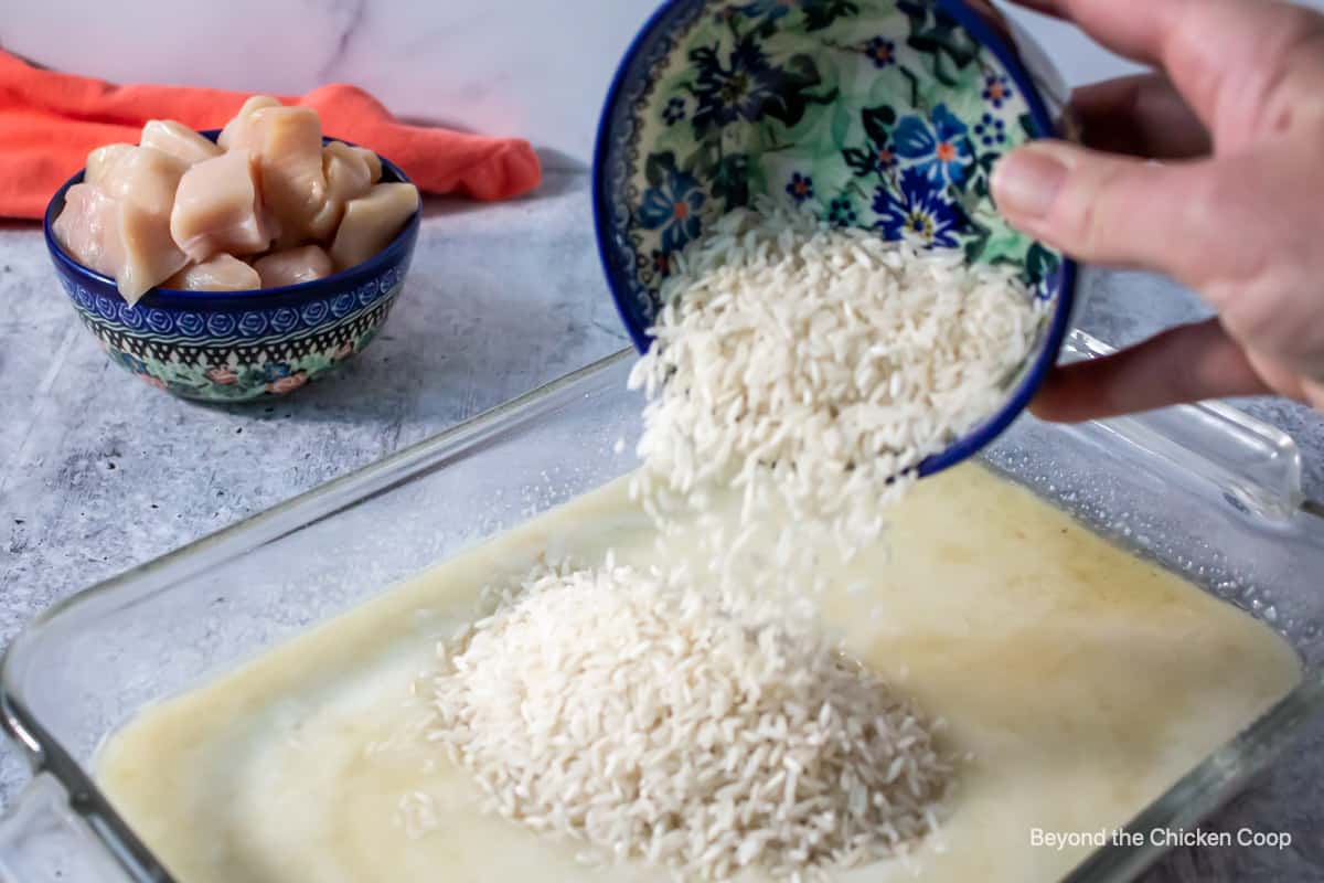 Pouring rice into a casserole dish.