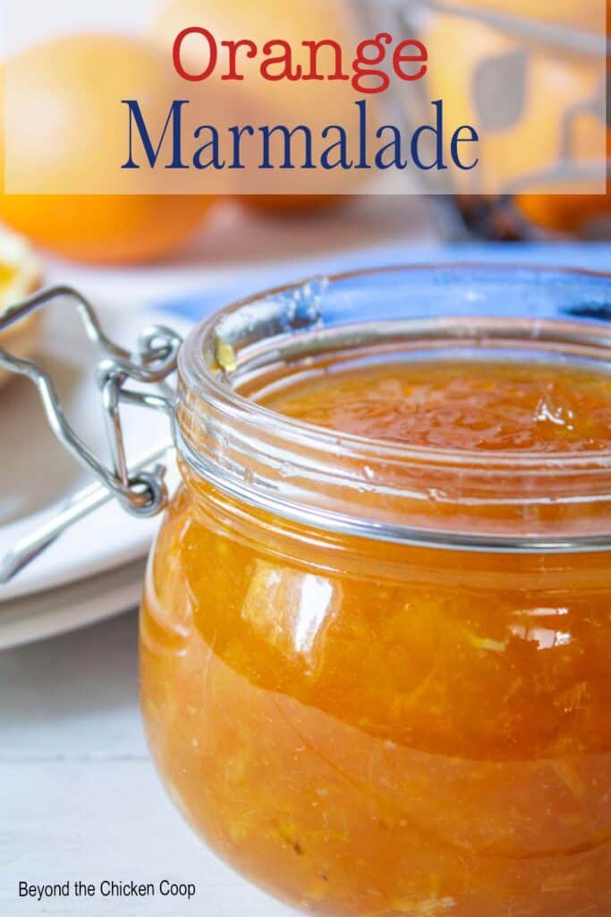 Brightly colored jam in a glass jar.