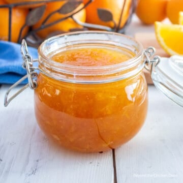 Orange marmalade in a glass crock.