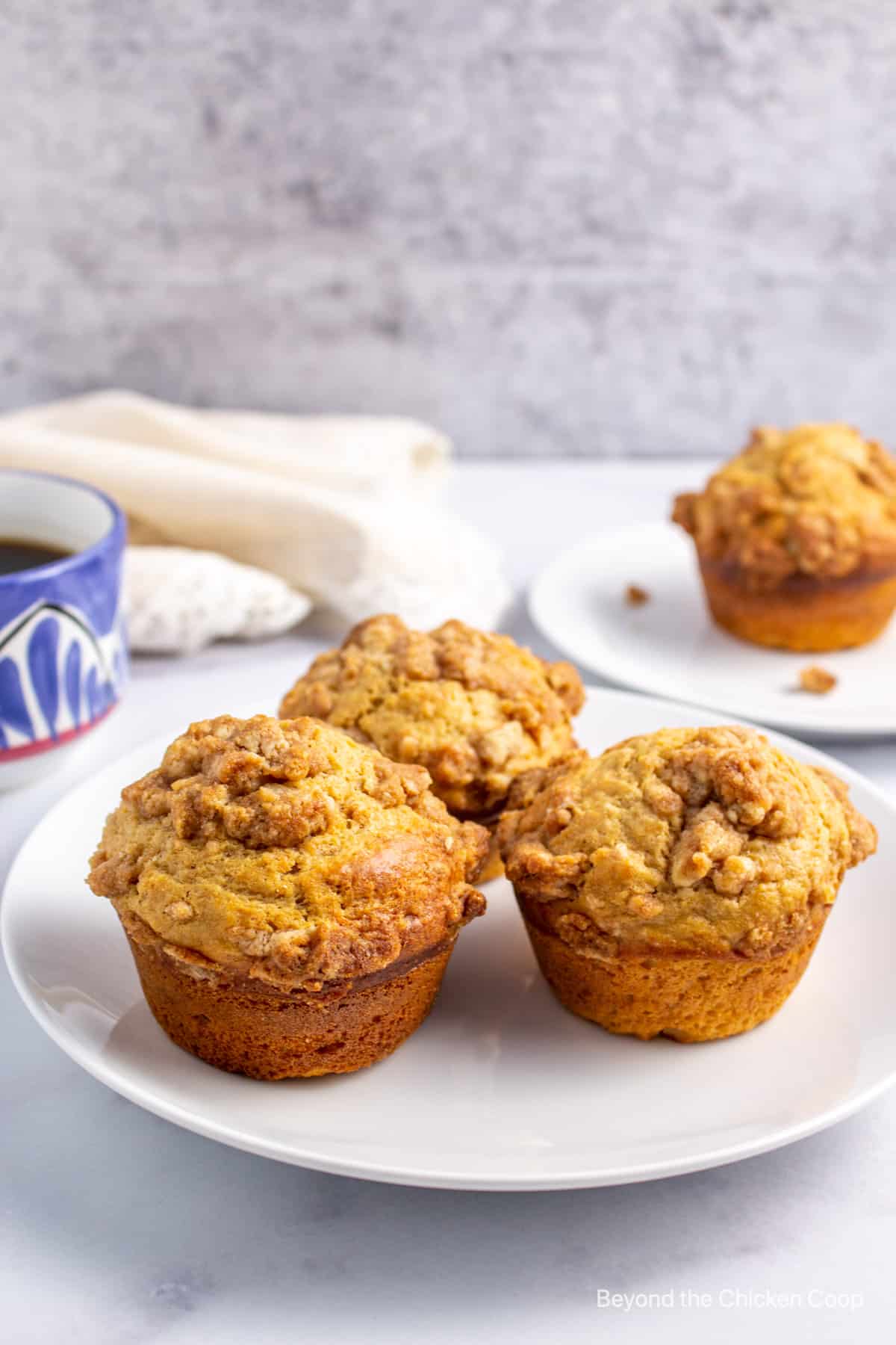 Three muffins with a crumble topping.