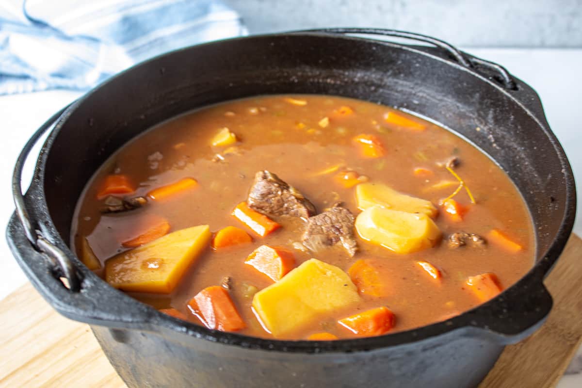 A cast iron pot filled with venison stew.