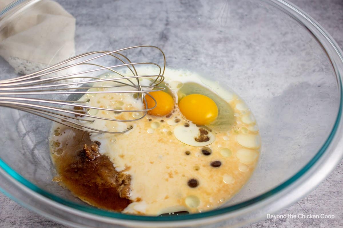Eggs, milk and oil together in a mixing bowl.