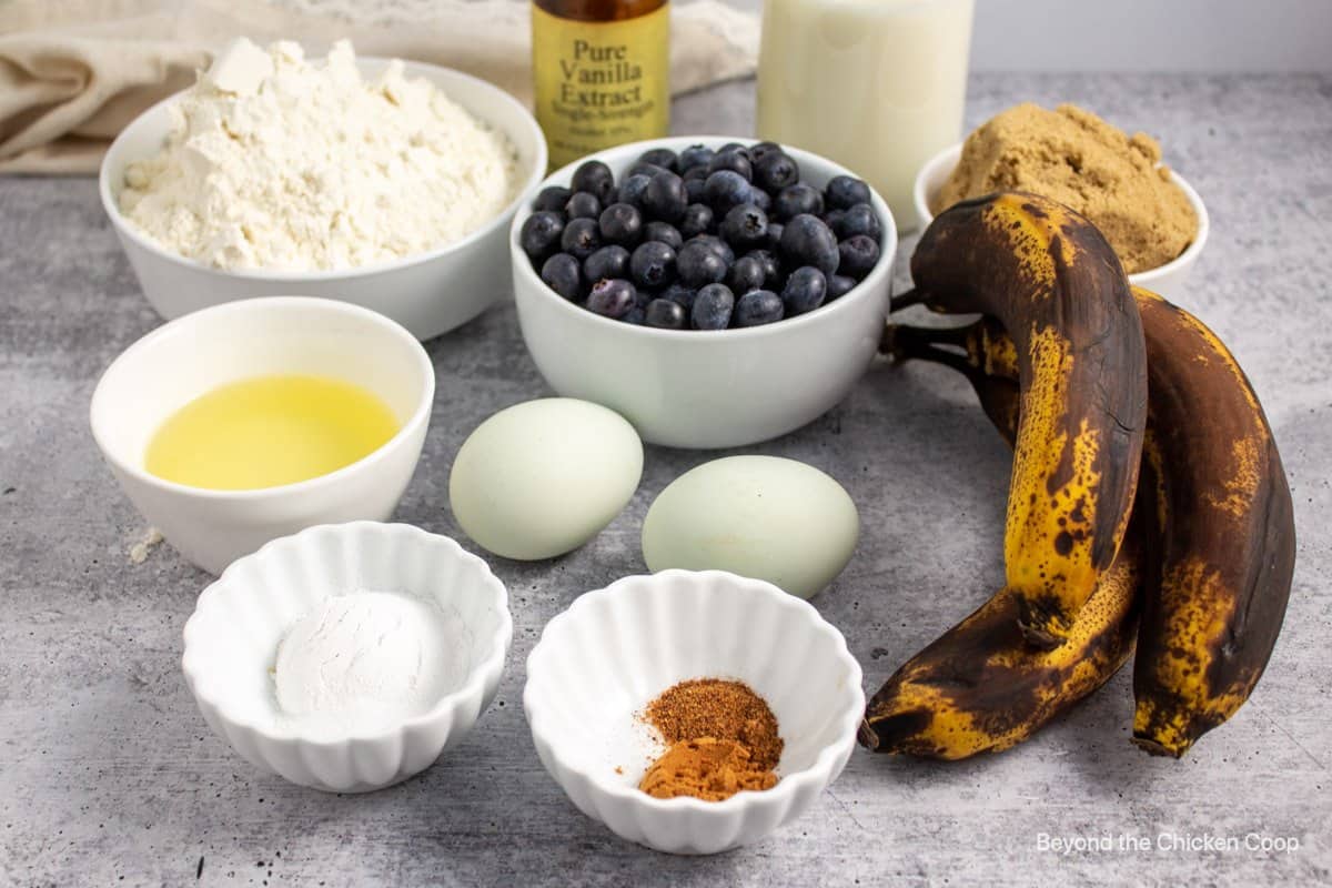 Ingredients for making muffins with bananas and blueberries.