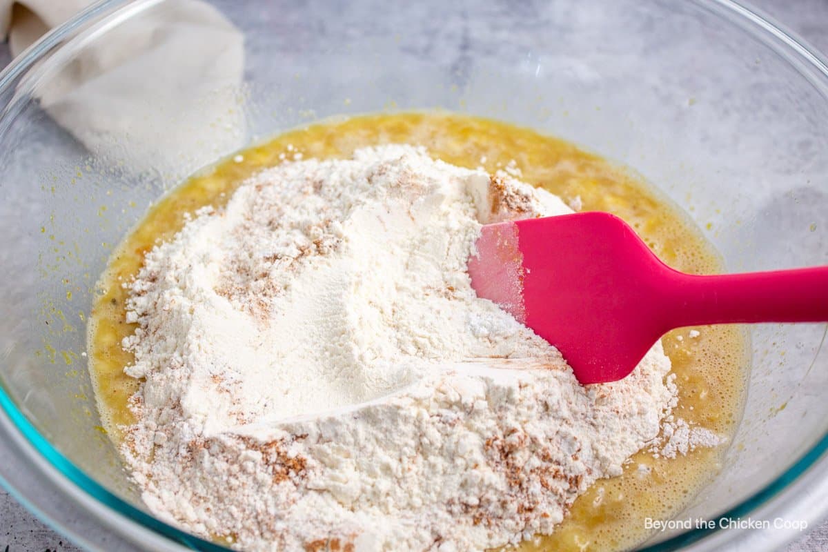 Mixing flour into wet ingredients.