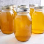 Canning jars filled with chicken stock.