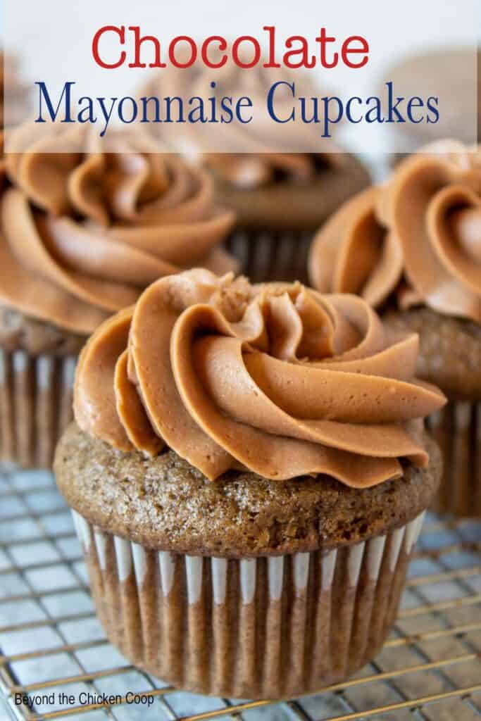 A baking rack filled with chocolate cupcakes.