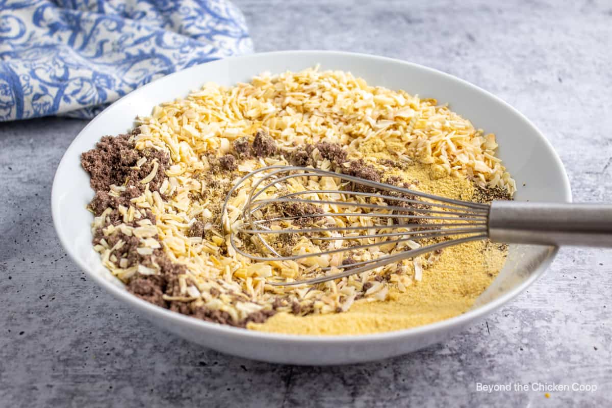 Using a whisk to blend spices. 