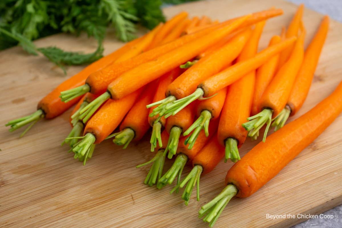 Peeled carrots on a cutting board.