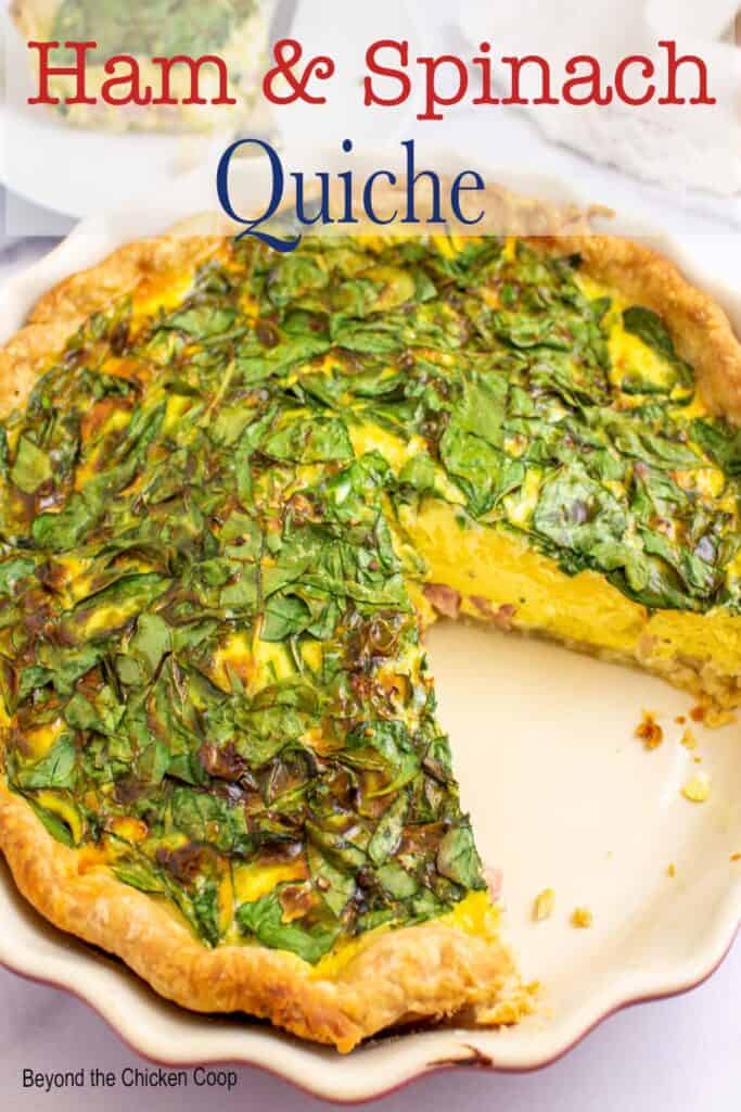 A deep dish quiche topped with spinach.