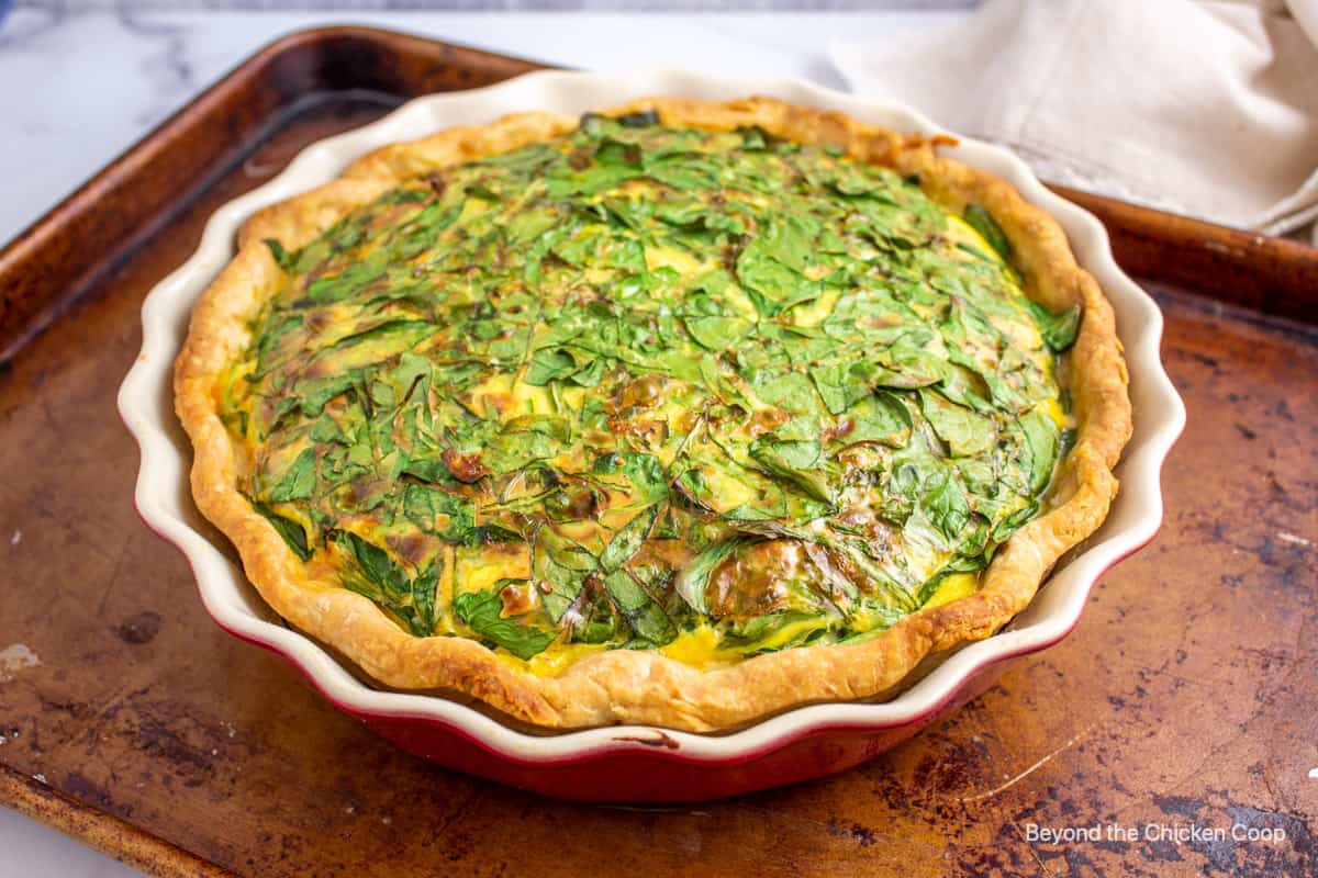 A cooked quiche on a baking sheet. 